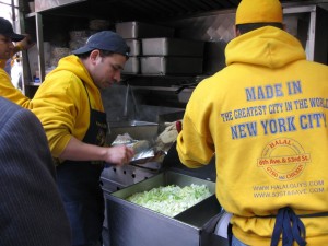 Men in Yellow Busy Making the Famous New York Chicken and Rice